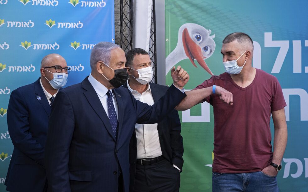 Helseminister Yuli Edelstein (midten) og statsminister Benjamin Netanyahu var til stede da Theodor Salzen (til høyre) ble nummer 4 millioner til å få den første vaksinedosene i Israel. Over 70 prosent av dem over 16 har nå fått minst én vaksinedose. Arkivbilde.
 Foto: Alex Kolomoisky / NTB