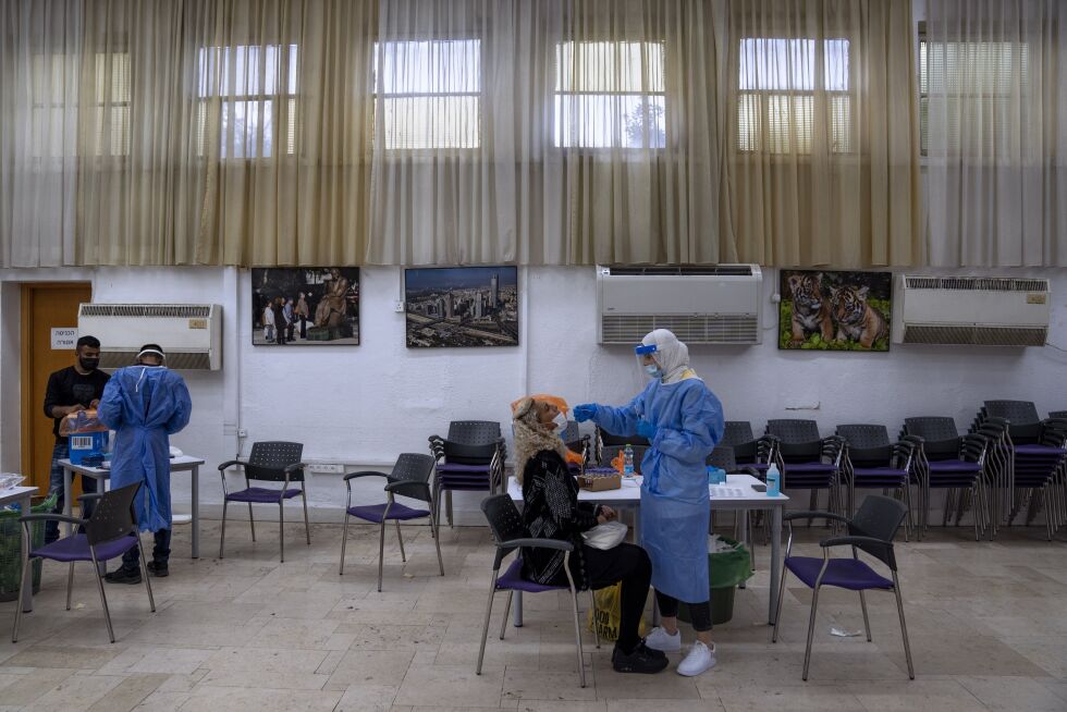 Bildet er fra et testsenter i Ramat Gan i Israel søndag 2. januar. Omikronvarianten sprer seg nå raskt i landet, som vil begynne å tilby eldre og helsearbeidere en fjerde vaksinedose.
 Foto: Oded Balilty / AP / NTB