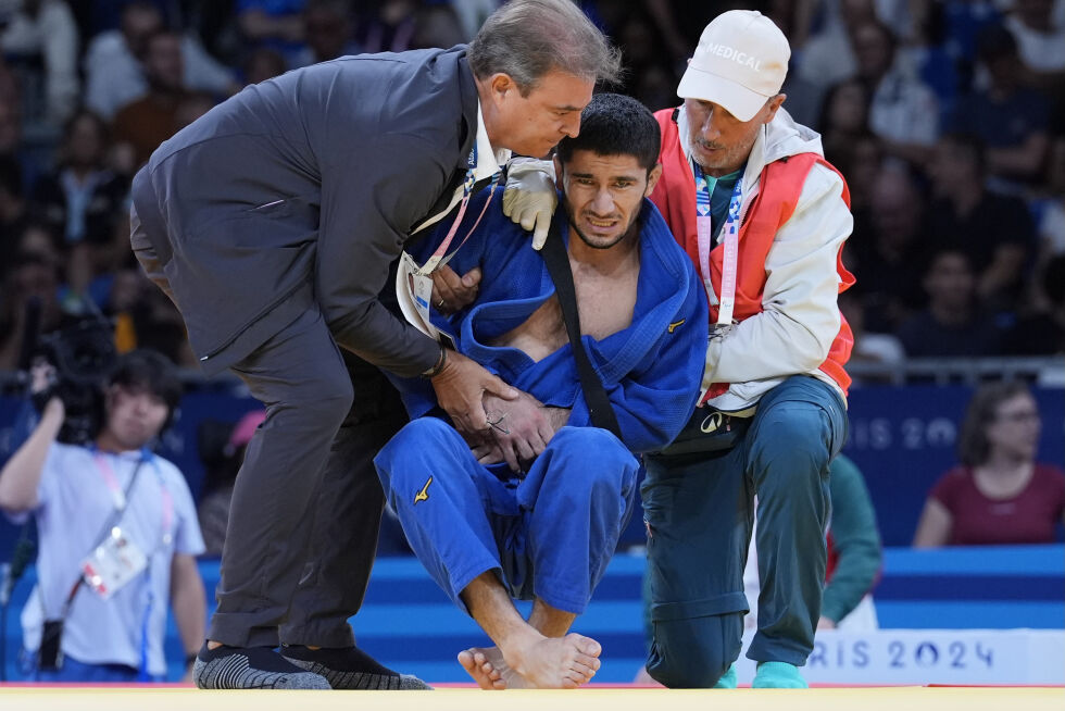 Tadsjikistans Nurali Emomali får behandling etter kvartfinalekampen for menn -66 kg mot Japans Hifumi Abe i lagjudokonkurranse på Champ-de-Mars Arena under sommer-OL 2024, søndag 28. juli 2024, i Paris, Frankrike.
 Foto: AP Photo/Eugene Hoshiko/NTB